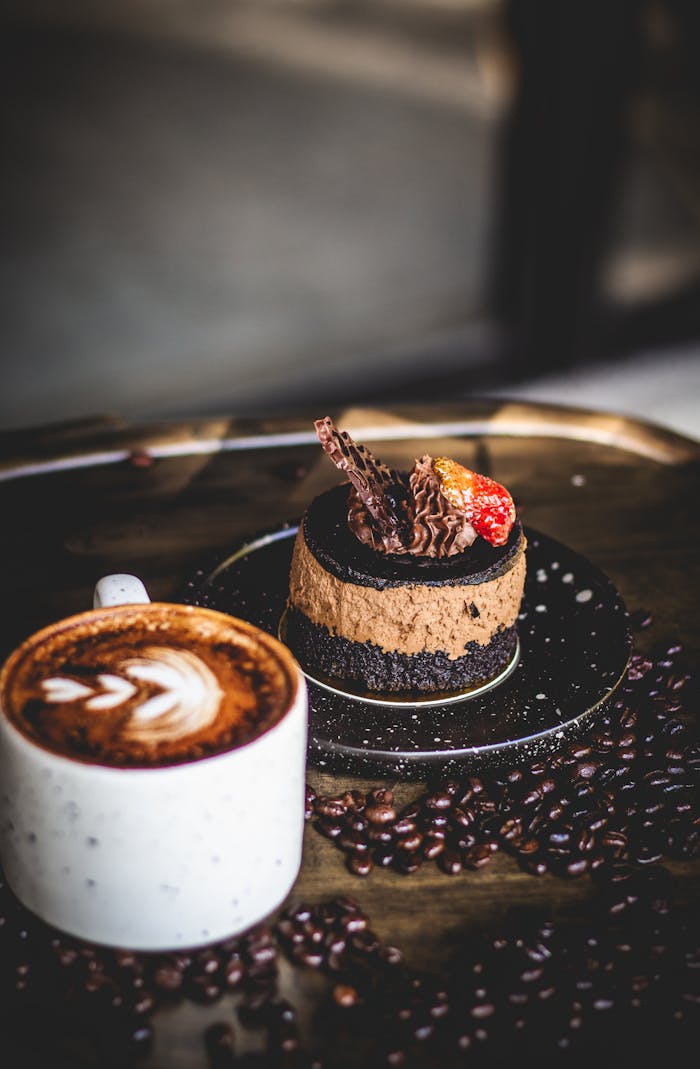 TUTORIAL CHAPTER 1 Indulge in a gourmet coffee with chocolate dessert, beautifully styled on a tray of coffee beans.