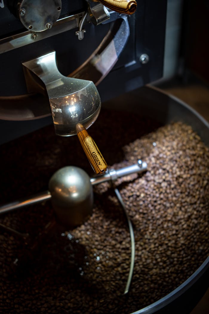 Close-up of roasted coffee beans in a coffee roaster. Perfect for coffee enthusiasts and cafes.
